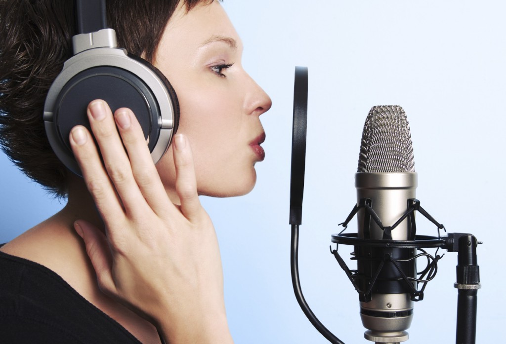 Woman doing VoiceOver in a recording studio.