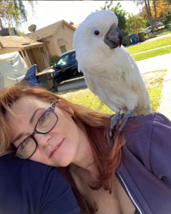 Dedee Pfeiffer with her Cockatoo