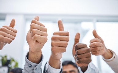 A positive attitude makes all the difference. Shot of a group of businesspeople showing thumbs up.