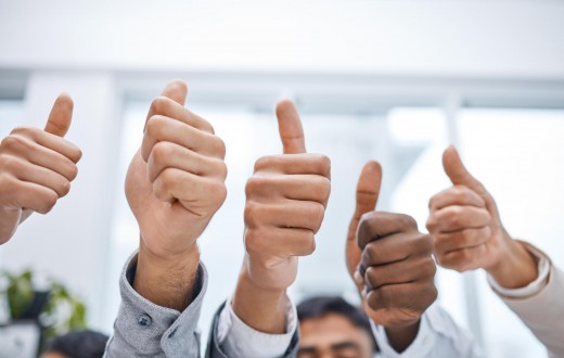 A positive attitude makes all the difference. Shot of a group of businesspeople showing thumbs up.