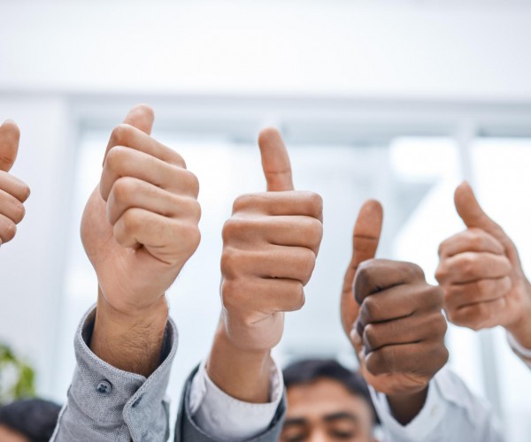 A positive attitude makes all the difference. Shot of a group of businesspeople showing thumbs up.