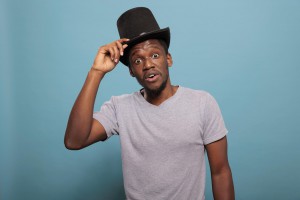 Portrait of adult with classic top hat on head in front of camera